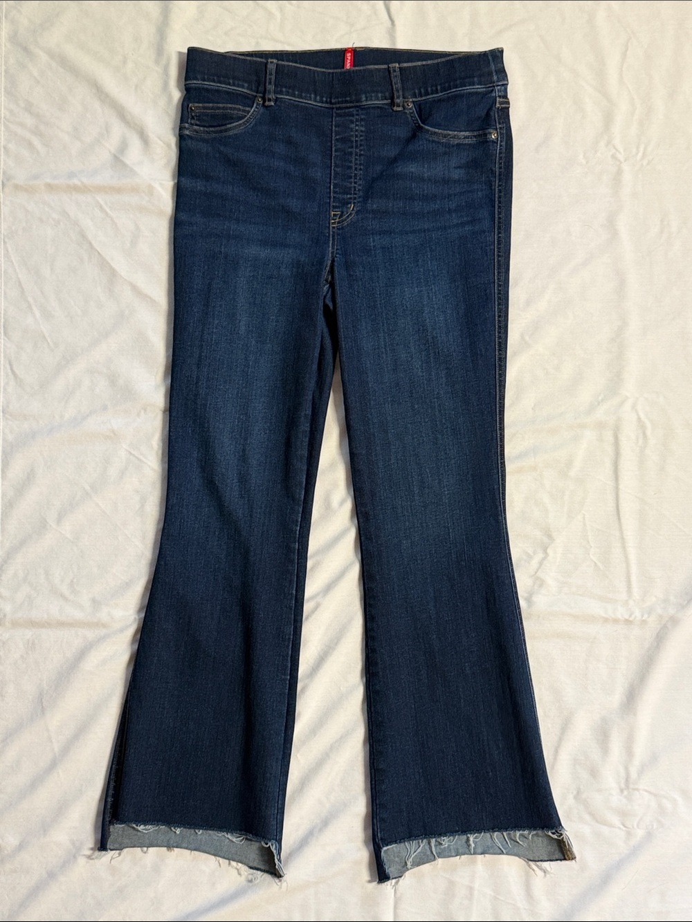 SPANX Sz L Dark Blue Flare Jeans with High Low Raw Hem